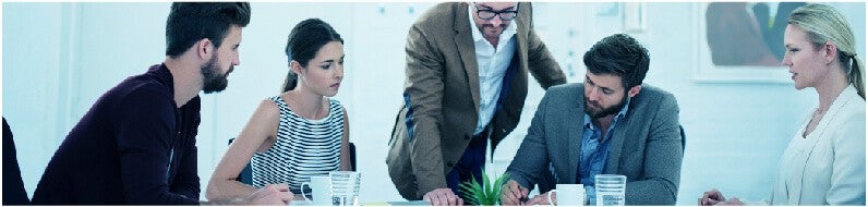 Five people having a meeting about customer feedback in an office.