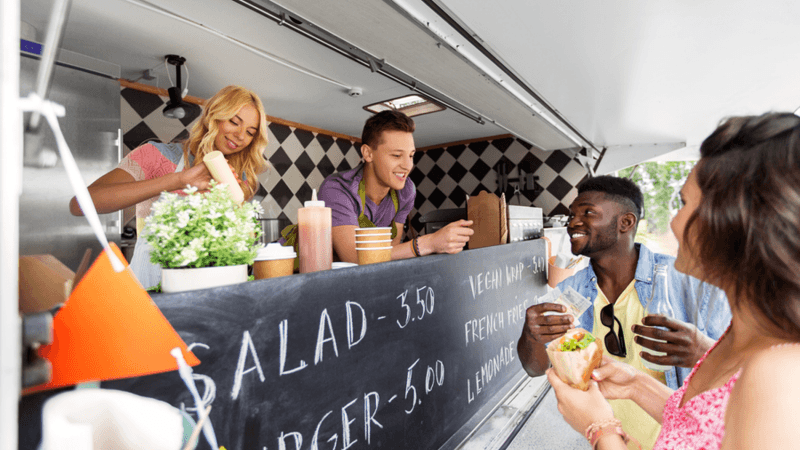 Customers purchasing from a food truck.