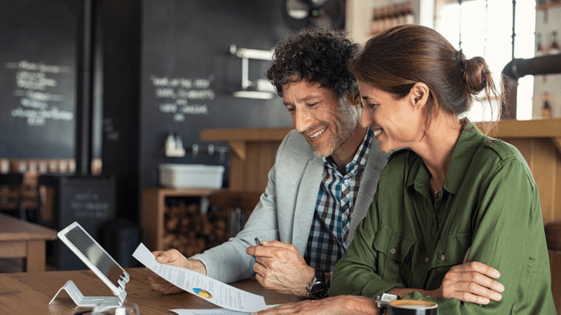 Happy couple looking at a document together.