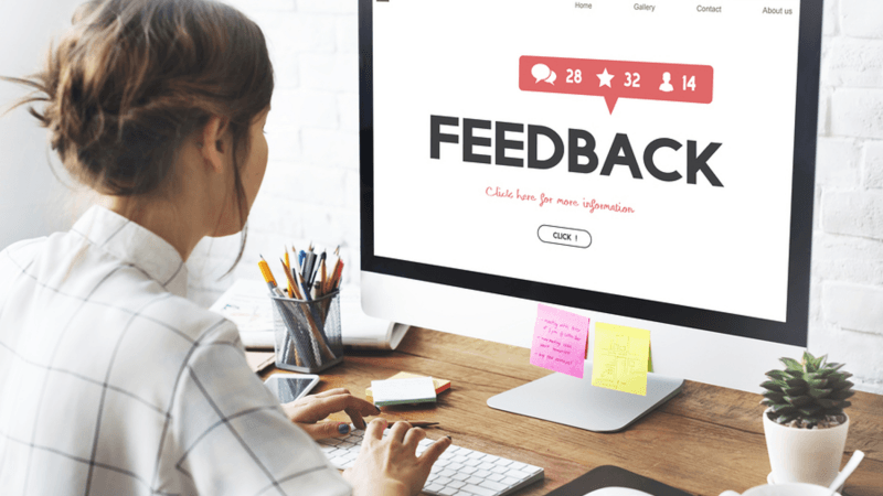 Woman filling out a feedback form on her desktop computer.