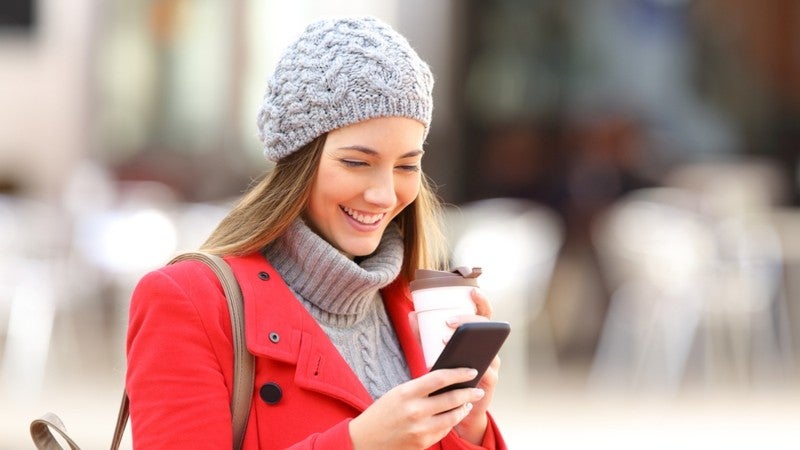 Woman using her phone to search for local businesses.
