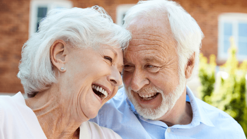 Elderly couple smiling.