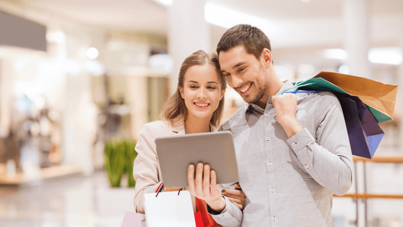 Customers leaving feedback using a tablet.