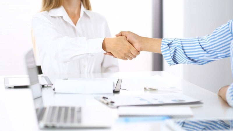 Two people shaking hands.