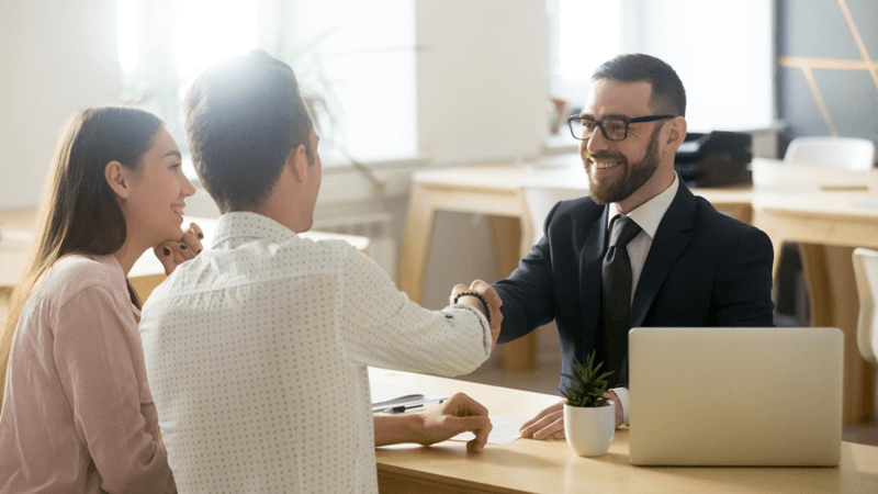 Two people meeting with a financial services professional.
