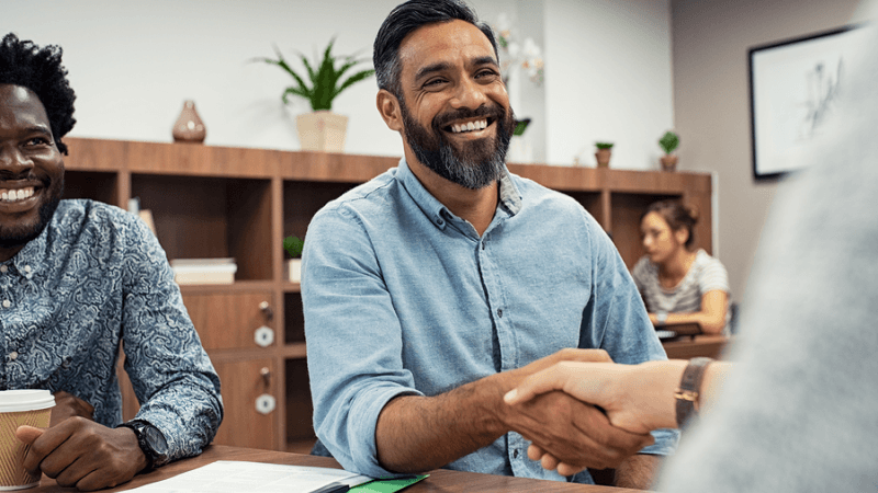 Happy man shaking hands with a businessman.