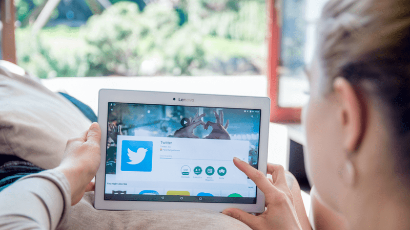 Person looking at their twitter app on a tablet.
