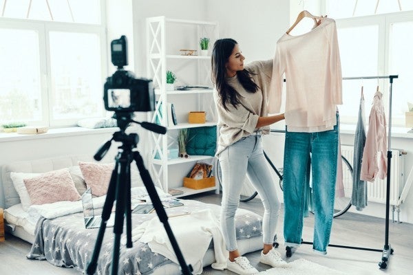 Woman taking photos of clothing for a shop. Woman taking photos of clothing for a shop.