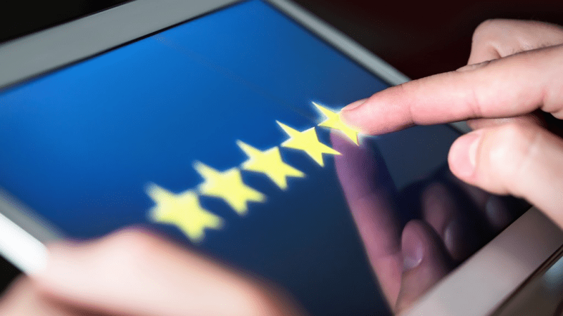 Person leaving a star rating using their tablet.