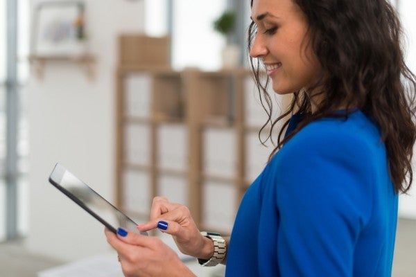 Woman typing on a tablet. Woman typing on a tablet.