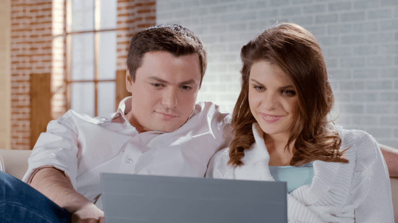 Couple looking at a laptop.
