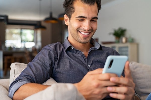 Smiling man looking at his phone. Smiling man looking at his phone.