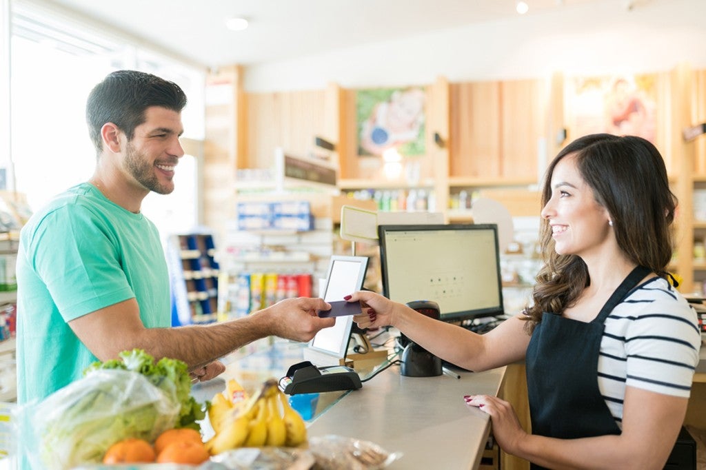 Customer making a purchase in a shop with a credit card. Customer making a purchase in a shop with a credit card.