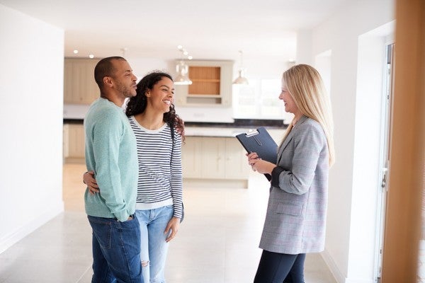 Couple meeting with a realtor in a new home. Couple meeting with a realtor in a new home.