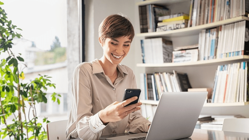 Smiling woman looking at her phone.