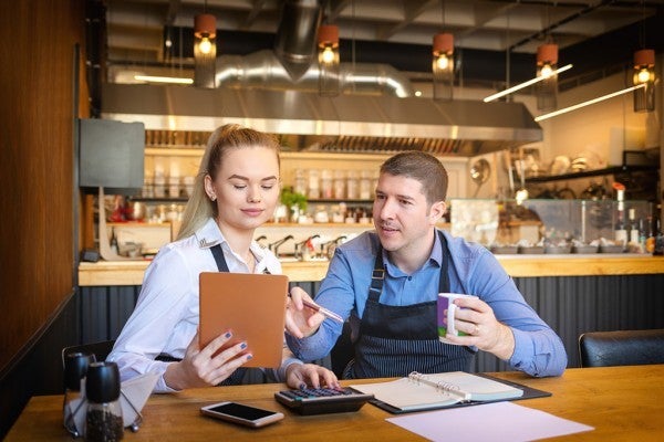 Restaurant owners discussing their marketing plan. Restaurant owners discussing their marketing plan.